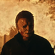 Michael Myers in Halloween Kills, walking away from a blazing house fire.